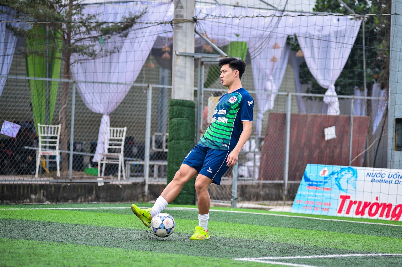 services-01 A young football player practicing on an artificial turf field in Hanoi, Vietnam.
